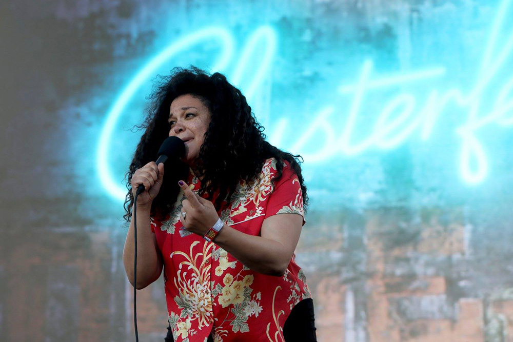 Image of African American woman holding mic doing stand up comedy